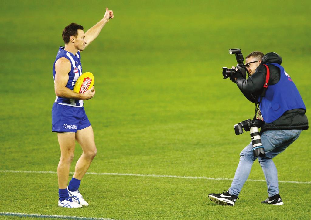 ON THE JOB: Michael Willson takes footy supporters up close, as this shot of him in action shows clearly.