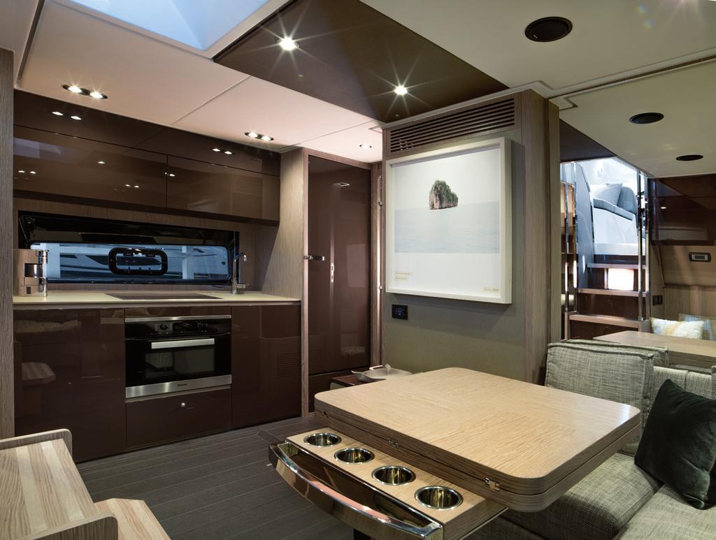 A unique layout on the below level offers a central living area, fully equipped galley and three