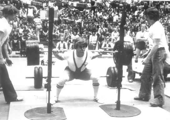 1977 Epley adds a 1700 sq. ft. room in the Coliseum for women athletes. Tim Evans squats 620 as a freshmen for the UNL weightlifting club at a demonstration at halftime of a basketball game.