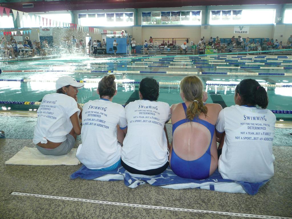 Swimmers have a choice of royal blue or pink cap in either silicone or latex. (Boys on the team generally wear the pink caps because they are so recognizable from the spectator area.
