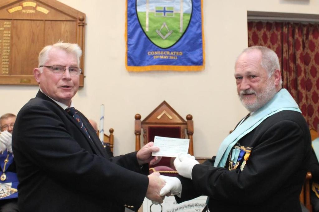 Busy fixture for Rugby Lodge Profits from Masonic Regalia Sales are donated to the 2018 Festival and proprietor, Steve Dodson, presented a further cheque to the Provincial Grand Master, on this
