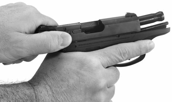 5. Hold the pistol firmly in the shooting hand but do not touch the trigger. Keep the pistol pointed in a safe direction.