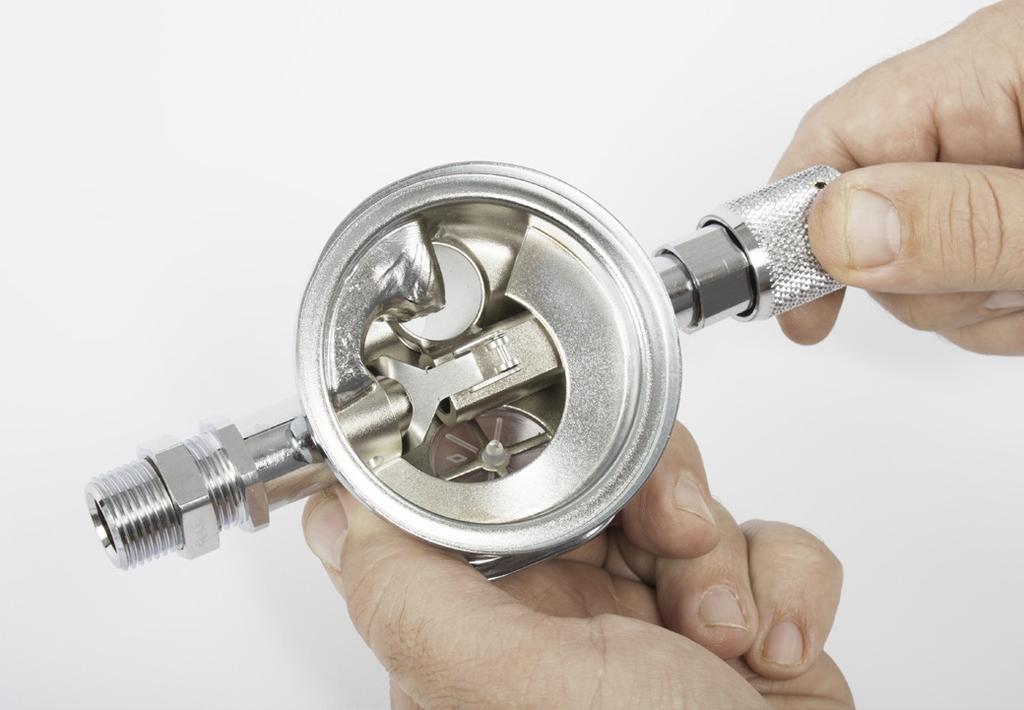 spring while forcing the threaded portion of the shaft stem into the interior of the regulator body. Place the washer and the spacer over the end of the inlet valve stem.