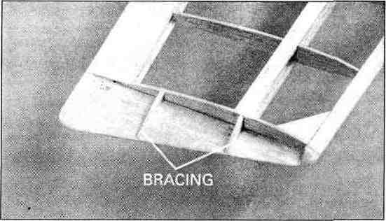 on the table, use medium CA to glue the balsa shear webs to the front and back of the spars, between the R3 and R4 ribs, and to the front of the spars from R4 to R8. Q Q 19.