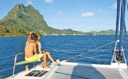 Otemanu from the Bora Bora lagoon; Julie hails a passing cruiser.