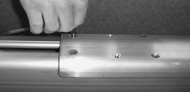 Use a torx key. NOTE: The cover for F265 has two pair of countersunk holes for the E-screws.