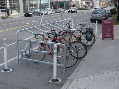 3: Convert three (3) separate on-street automobile parking spaces into seasonal bicycle parking stations, by hooding the parking meters and placing a bicycle corral in the parking space.