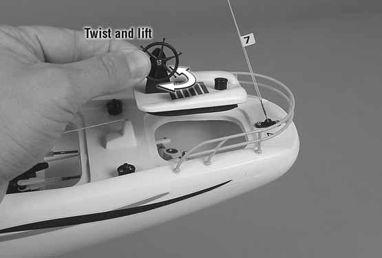Gently twist the helm pedestal and lift the rear hatch from the deck as shown.