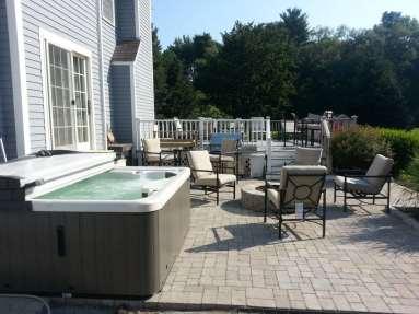 When designing your backyard patio where the hot tub is going to think about all the elements to pull people together during a backyard outing.