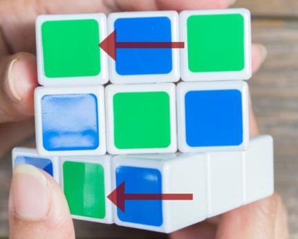 Begin by looking at the green side of your cube. Turn the right side of the cube two clicks forward.