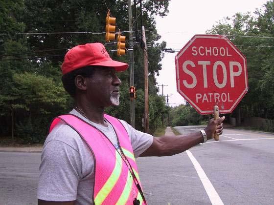 Adult School Crossing Guards Promote safe behavior