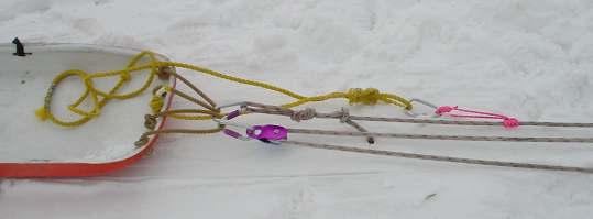 This end of the line will also be tied with a follow through Figure 8 knot (anchored to yellow webbing). The belay device will be used to lower the load.
