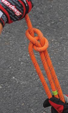 Hold the loop with the left thumb on top. 2 Take the free end of the 3 Pass the working end rope and pass it through around the back of the the loop.