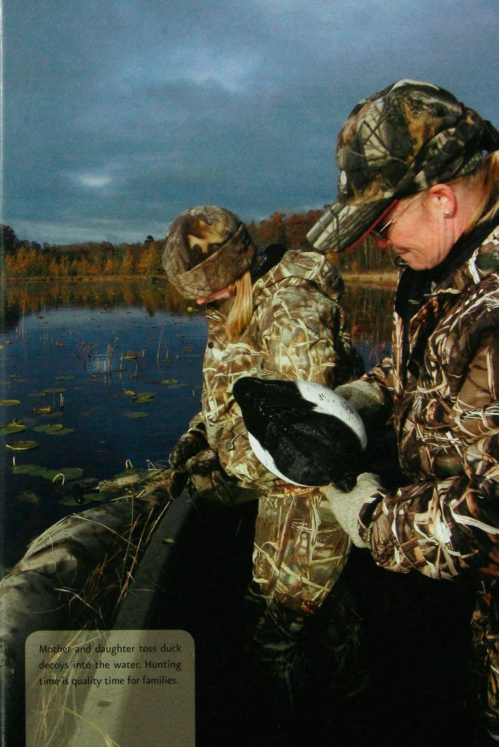 Mother and cfeughter toss duck decoys into the