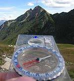 The letters on a compass are N for North, E for East, S for South, and W for West.
