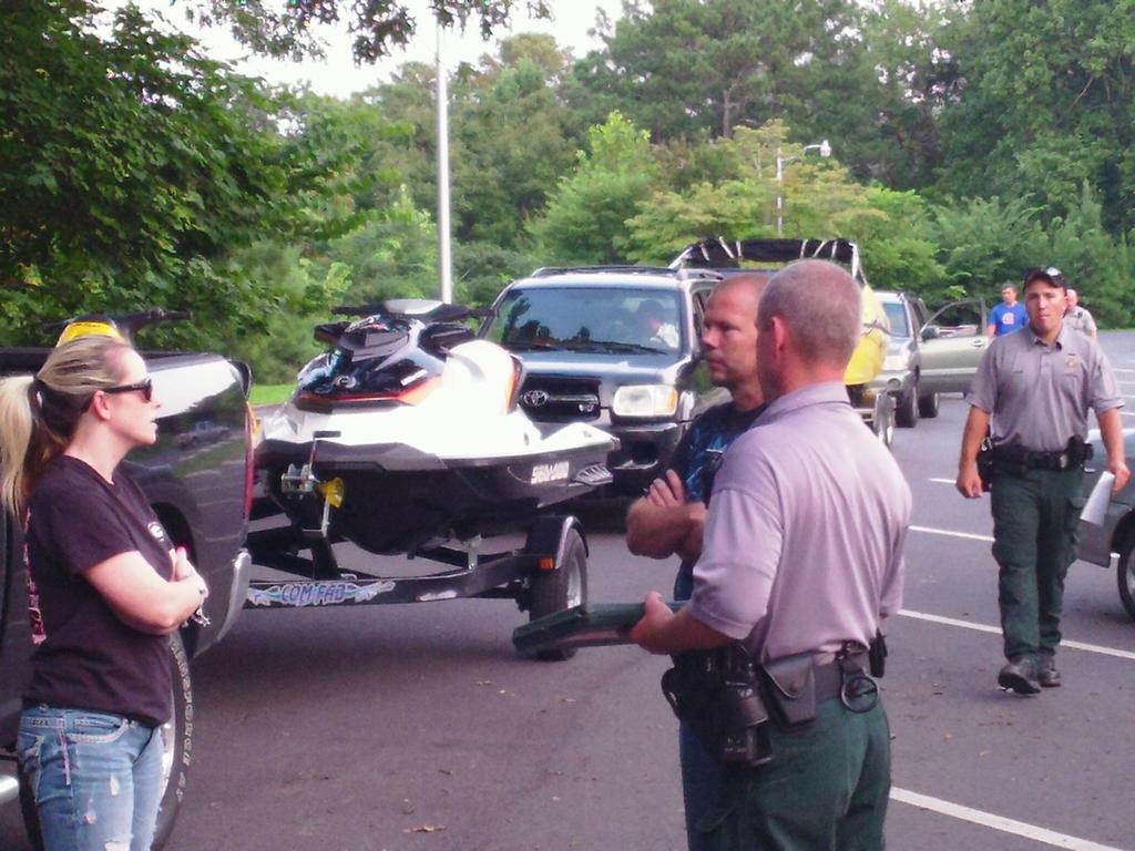 DNR Rangers Bart Hendrix, Zack Hardy and Brooks Varnell are shown assisting the public with registering their boats. On August 24 th just after midnight, Cpl.