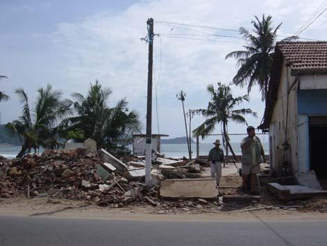 2 m, where a house at the sea side was damaged but barely remained as shown in Photo 4.