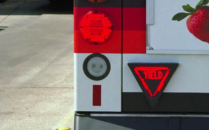 Some jurisdictions (e.g., Québec and Washington) remind motorists of the law through the use of stickers mounted to the back of the bus.