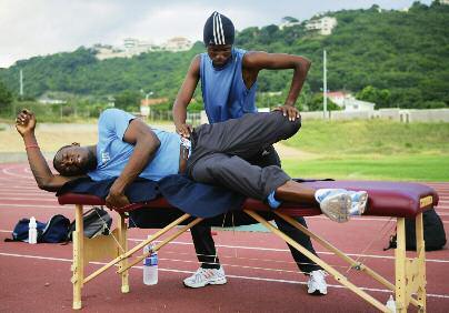 World Programmes Jamaican sprinter Usain Bolt, Olympic scholarship holder, goes through his stretching routine with his physiotherapist, Miki Rubens, at the Kingston national stadium Getty