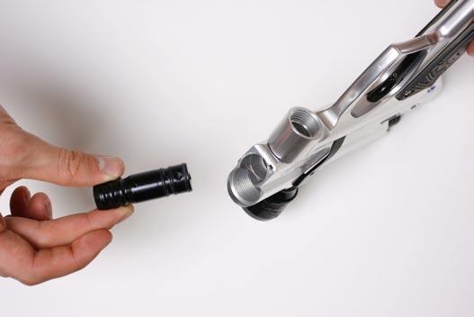 Grasp the low pressure regulator to ensure that it does not eject from the marker upon removal of its retaining screw.