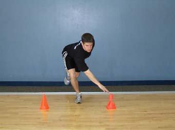 Stand on the right leg with knee flexed ~15 degrees and slowly reach the left hand to the cone on the right side of the body.