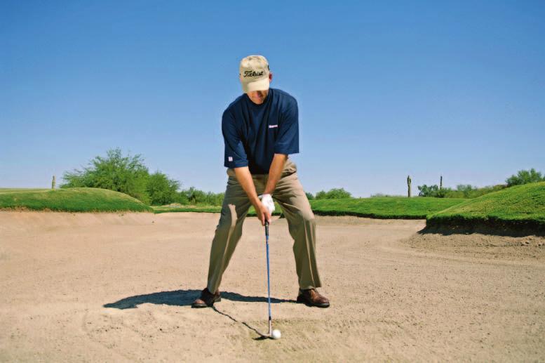 åc oming down, the legs drive forward, and the clubhead passes the ball through the sand.