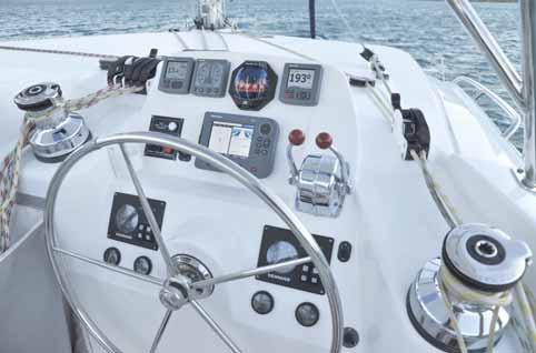 The helm station to starboard has wheel, engine controls, sail controls, and electronics all close at hand.