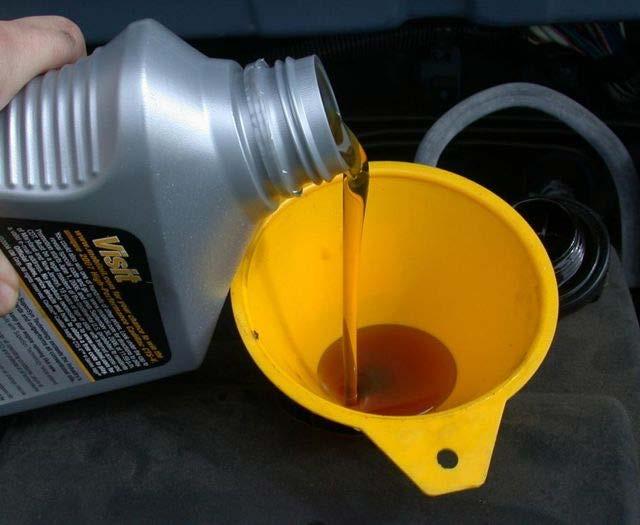 A funnel will help Add new oil to the car at the fill hole. The amount you need is in the owner's manual, usually listed under "capacities".