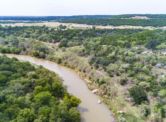 The property is dominated by a mix of live oak stands and expansive grasslands with cedar breaks running along the high country topography coming up from the river bottoms.