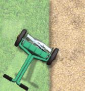 The wheel on the gravel slows down, but the other wheel is still moving at a faster speed on the grass. The speed difference between the two wheels causes the lawnmower to change direction.