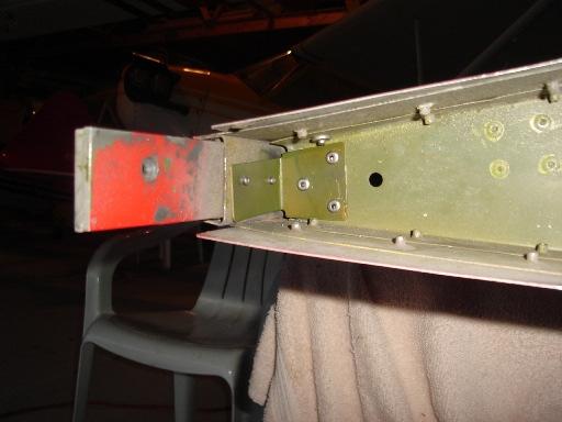 bracket using three CCP-42 and two CCP-46 rivets. The top skin rivet was drilled out and replaced with a CCC-42 rivet and an 1/8 back up washer to accommodate the damaged hole in the rib.
