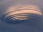"standing lenticular" cloud...because the air is moving but the cloud has the appearance of standing still. Rotors Figure 3.