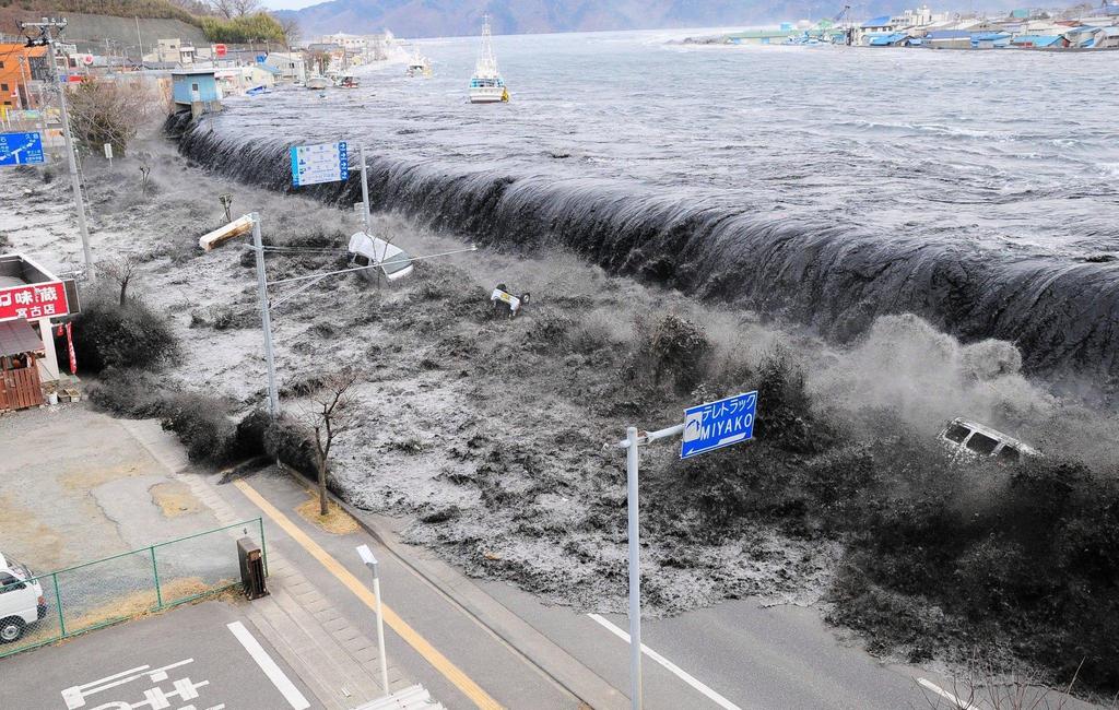 A tsunami wave crashes over a