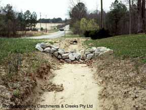 Permanent rock check dams can also be used to form a stable, terraced invert within mild-sloping (<10%) table drains. Permanent checks dams, however, can cause mowing problems.