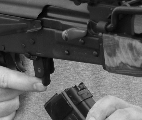 2. Press the magazine release lever (located at the front of the trigger guard) forward, to allow you to pull and remove the magazine from the receiver. (See Illustration #7.) 3.