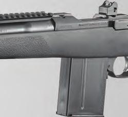 Detachable box magazine with push-forward magazine release just forward of the trigger guard.