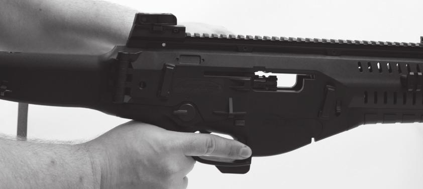 To use the lower magazine release button retract the bolt handle with one hand while applying upward pressure to the lower magazine release button with the