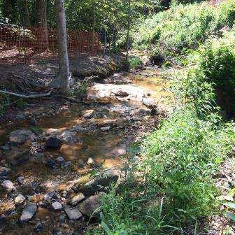 downstream from culvert outlet (~200 lf of sediment in