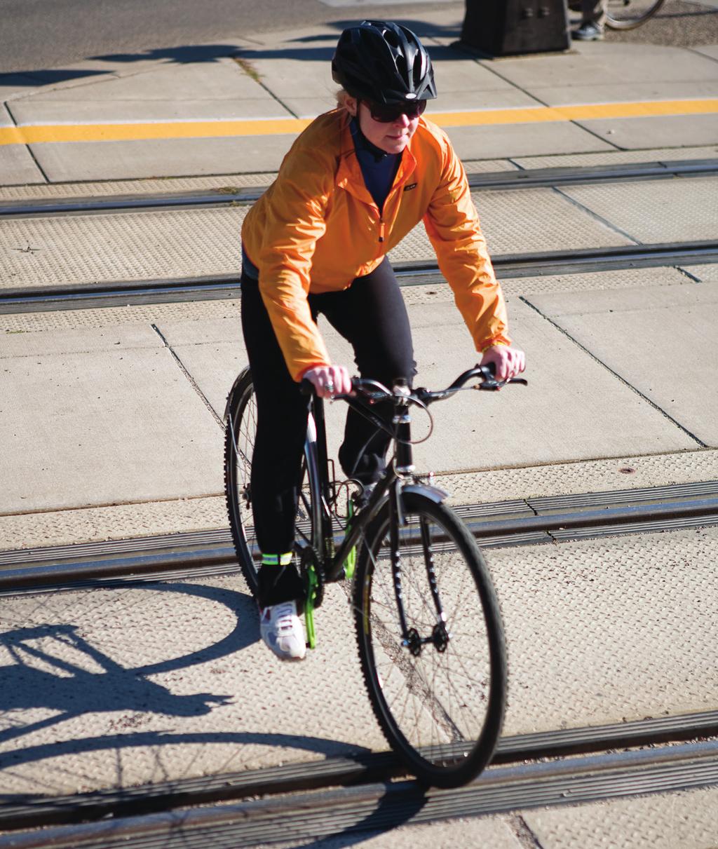 Cross train tracks, sewer grates and other obstructions at a right angle and transition your weight toward the back of the bicycle to prevent getting your wheel caught.