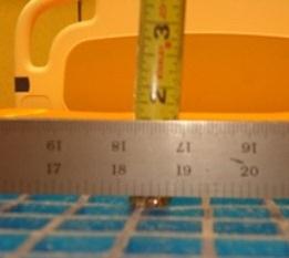 Note: Do not push down on the tape measure when taking the measurement. The tape measure should just lightly touch the top of the gel grid.