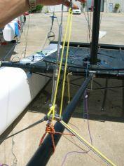 Using the center tension line, tighten the line to provide a prebend in the spin pole of 2-4.