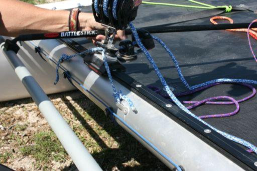 halyard hook at the top of the mast. Pull firmly on the foot of the sail several times to ensure that the ring is fully attached.
