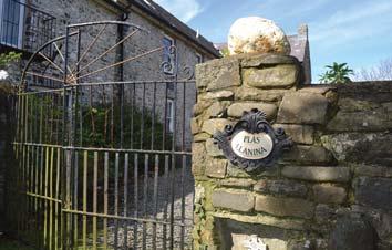 The wooden door ahead is the entrance to Plas Llanina, private home to a couple who, when they purchased the property ten years ago, were surprised to discover they were also getting a slice of