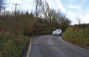 Stay on the right side of the road but, as there s no pavement, take extra care with the traffic. Where the road bends you may need to cross to the other side to get a better view of the traffic.