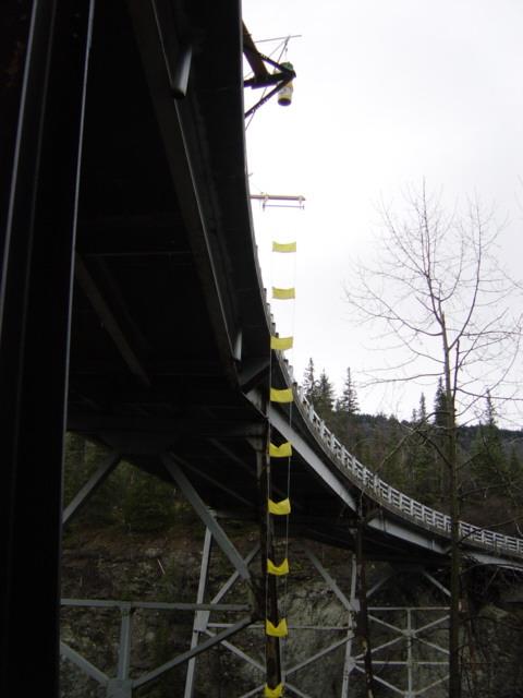 The tetrahedron was attached at the edge of the bridge so that the test mass could be suspended just past the drop edge.