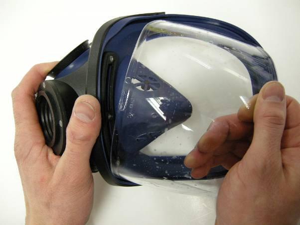 visor opening of the outer mask and is held in place by one upper and one