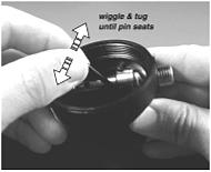 Guide the round inlet opening of the box bottom down over the valve body until the indexed features of both parts can be visually aligned with each other.