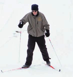 Spread the tips of your skis until they form a 90-degree angle, plant your poles behind the skis with each