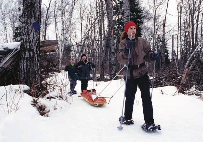 SKI TOURING AND SNOWSHOEING Skiing With a Sled Pulling your gear in a sled takes less effort than supporting the same weight in a pack on your back.