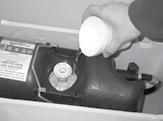 The Flush-Valve Cartridge can be removed by inserting the handles of a pair of pliers into the top of the Flush-Valve Cartridge and turning counter-clockwise.